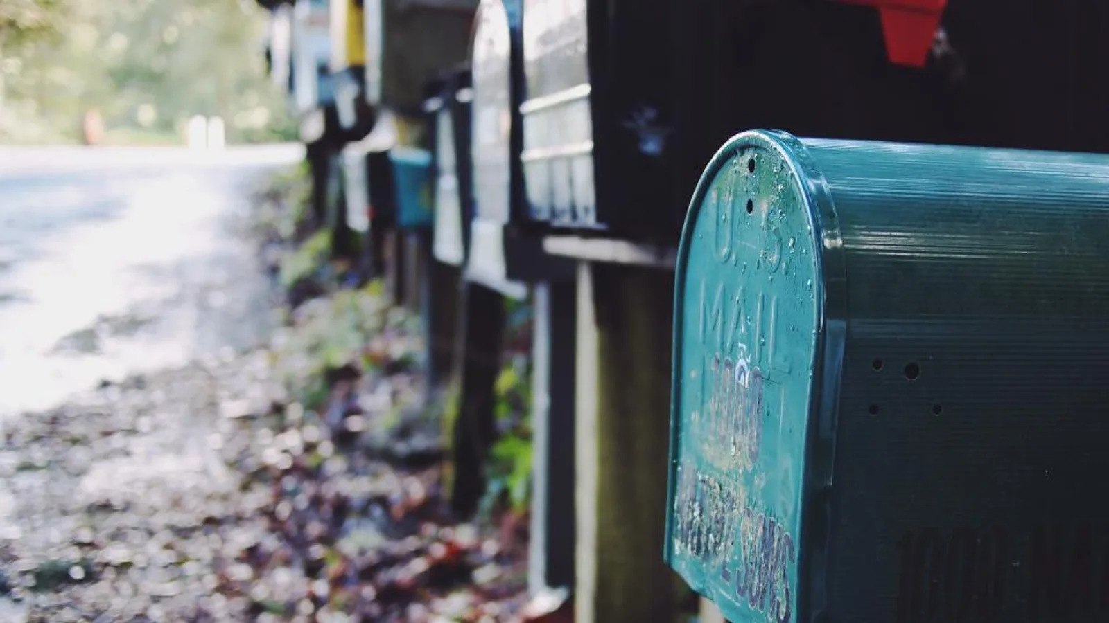 A row of mailboxes along a country road.